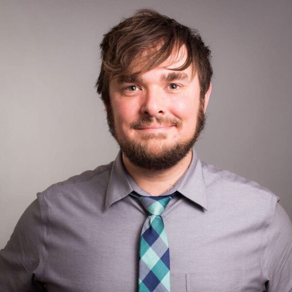 Man smiling and wearing a tie