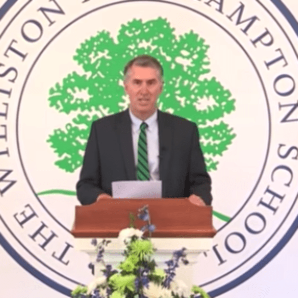 man at podium at graduation
