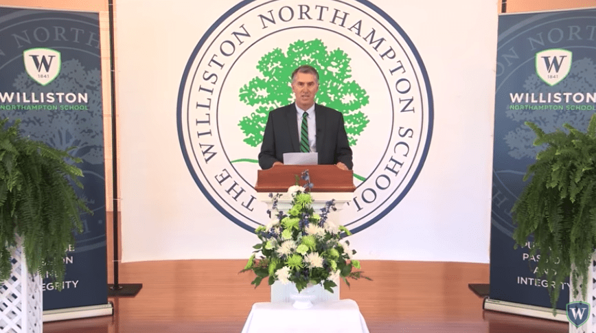 man at podium at graduation