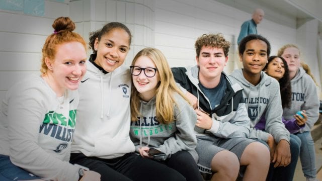 group of students in gym bleachers