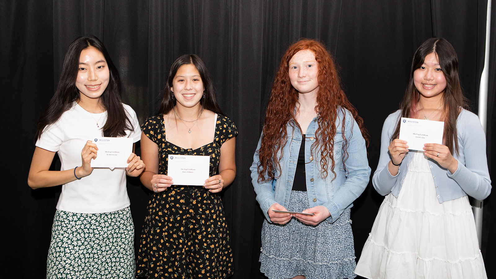 four girls holding awards