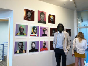 young man with images in art gallery