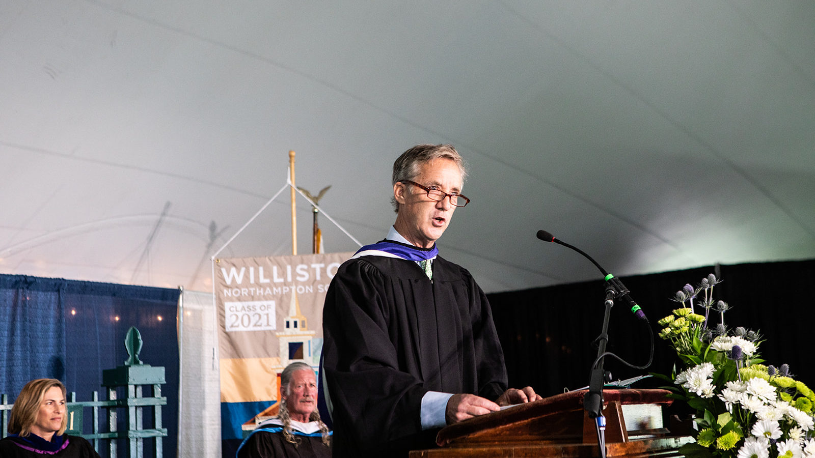 man in academic robe at podium