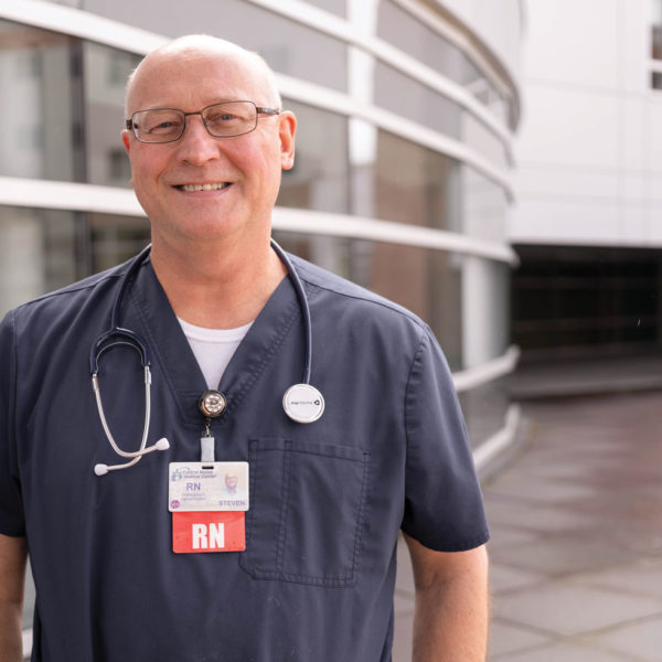 man with stethoscope outside hospital