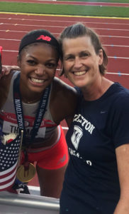 two women posing on a track