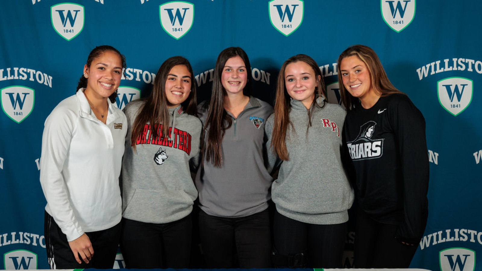 five girls with sports jerseys