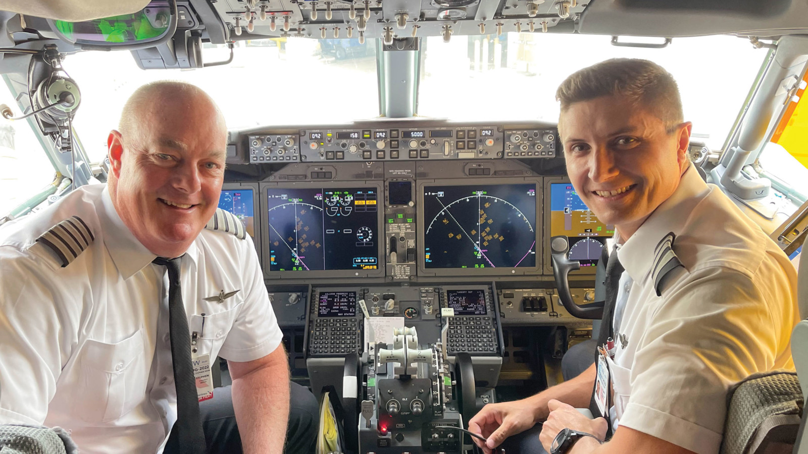 two men in the cockpit of an airplane