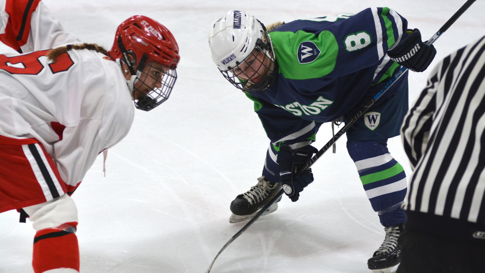 two girls face off on the hockey ice