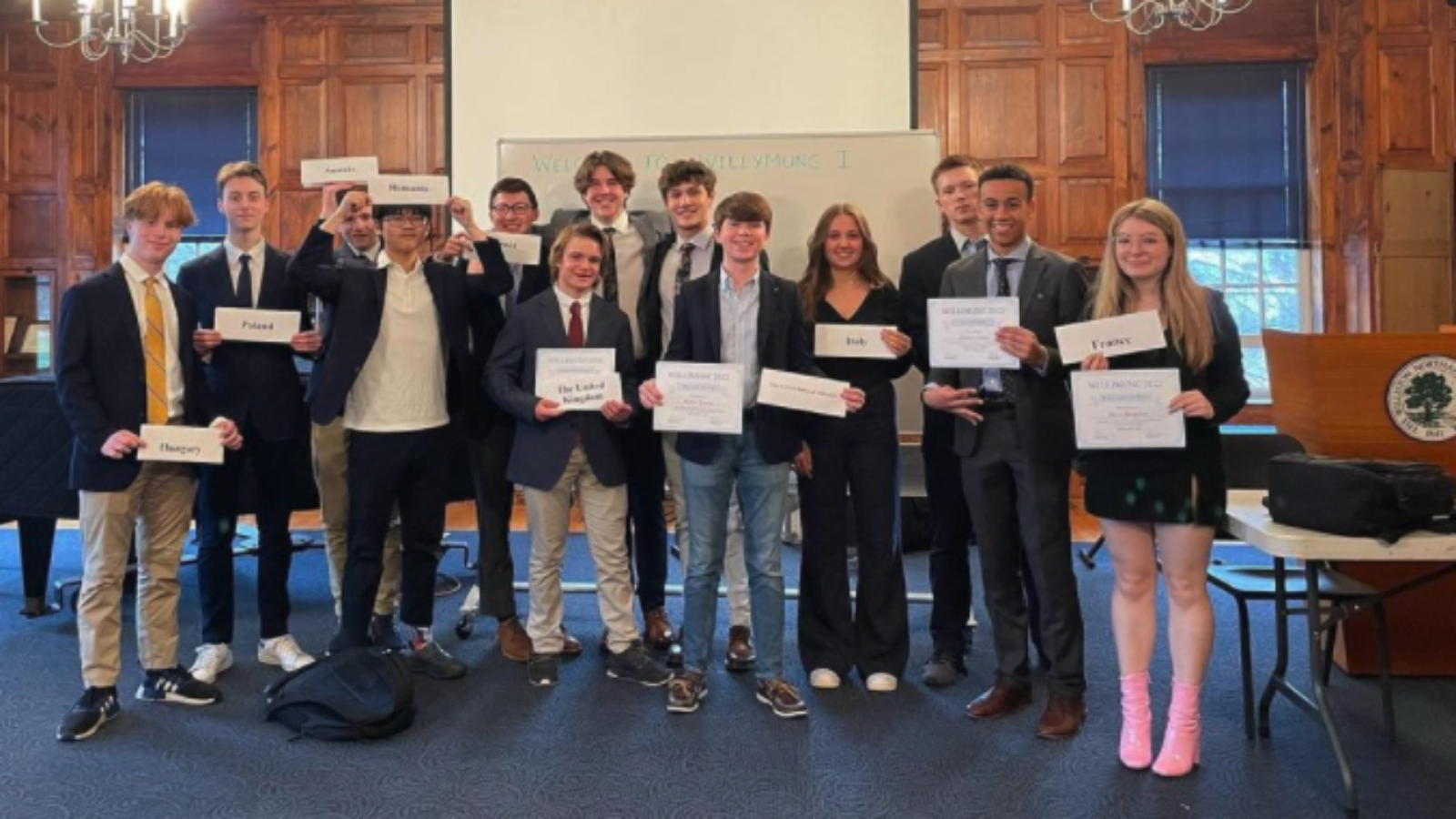 13 students holding signs