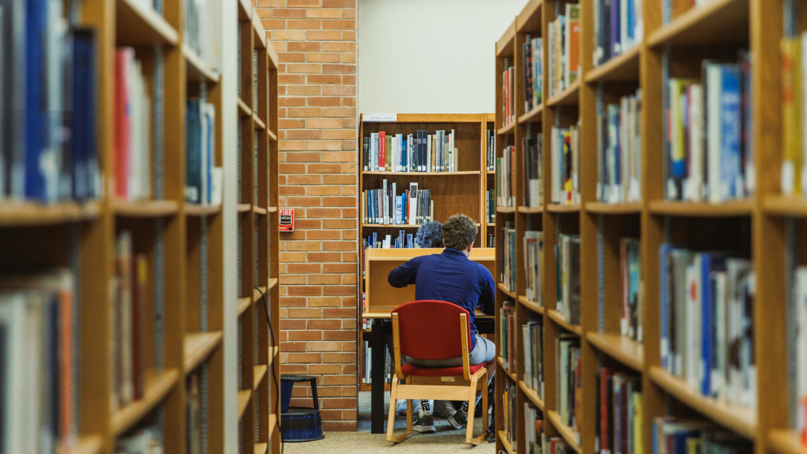 student amid stacks