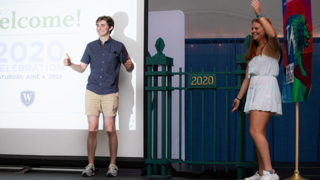 young man and woman showing section of fence