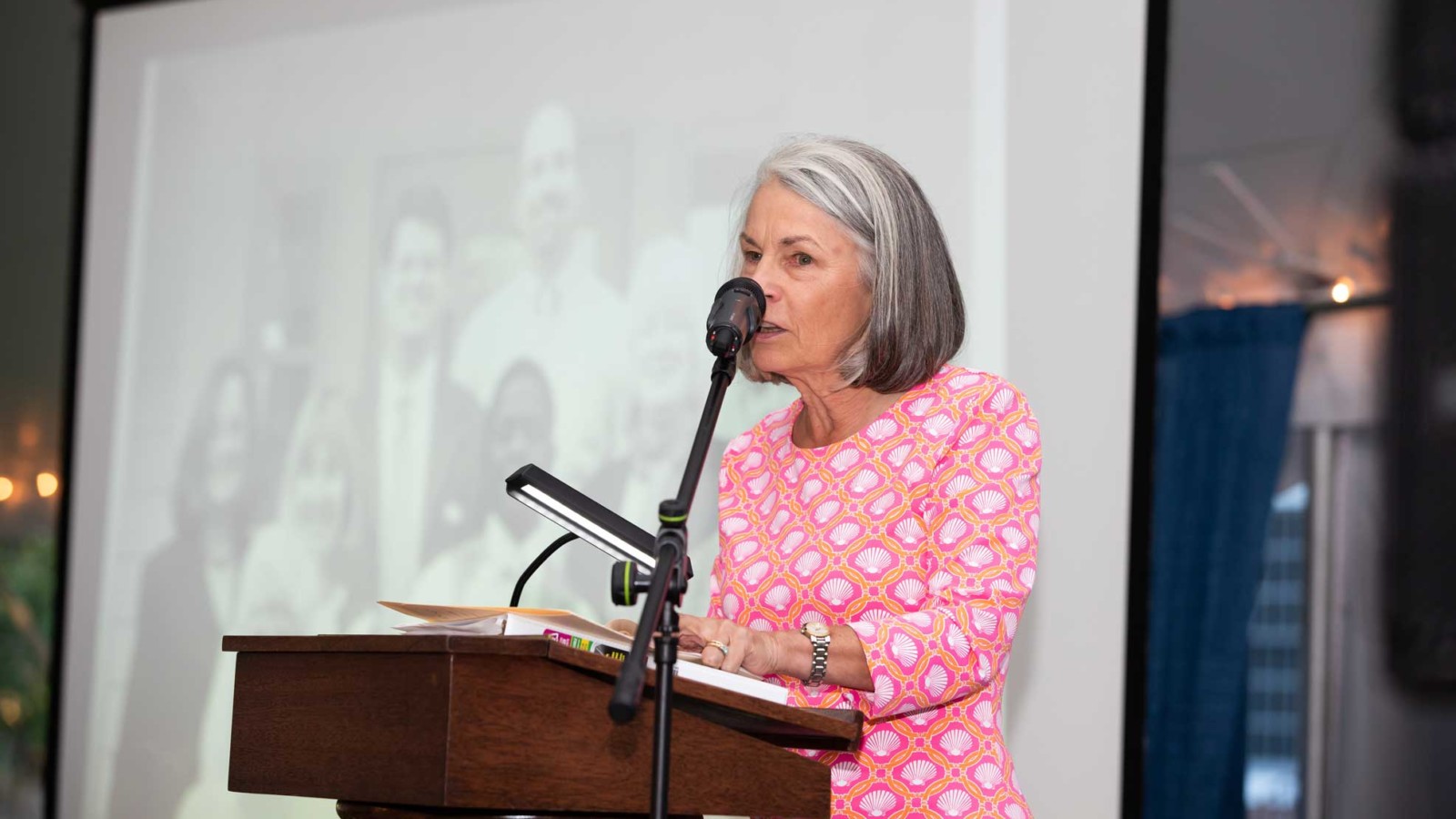 woman at podium speaks into mic