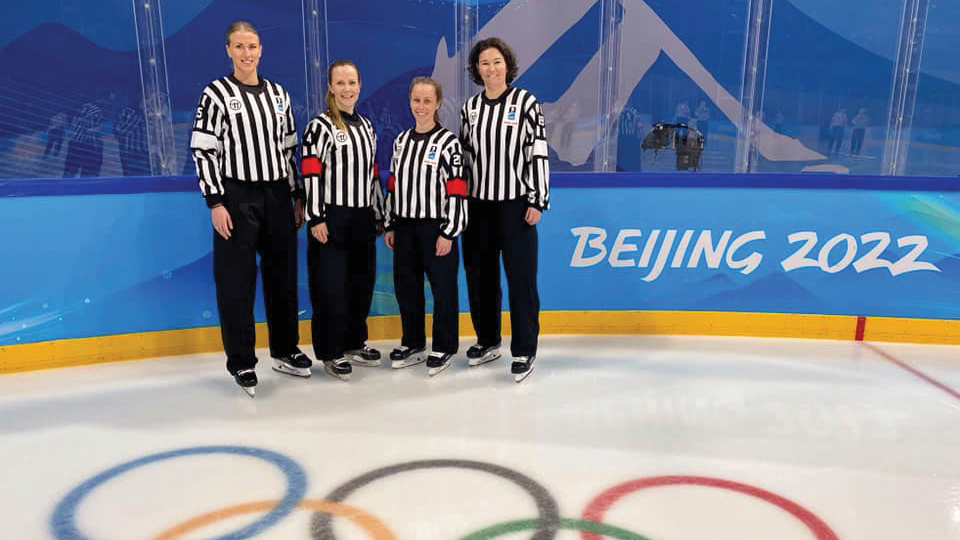 four hockey referees on the ice at Tokyo Olympics