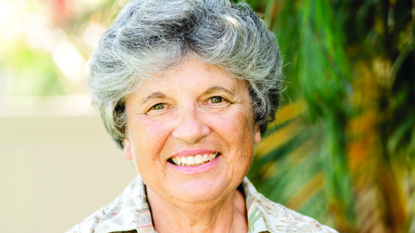 woman on patio with palm trees