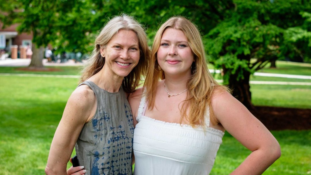 mom and daughter standing outdoors