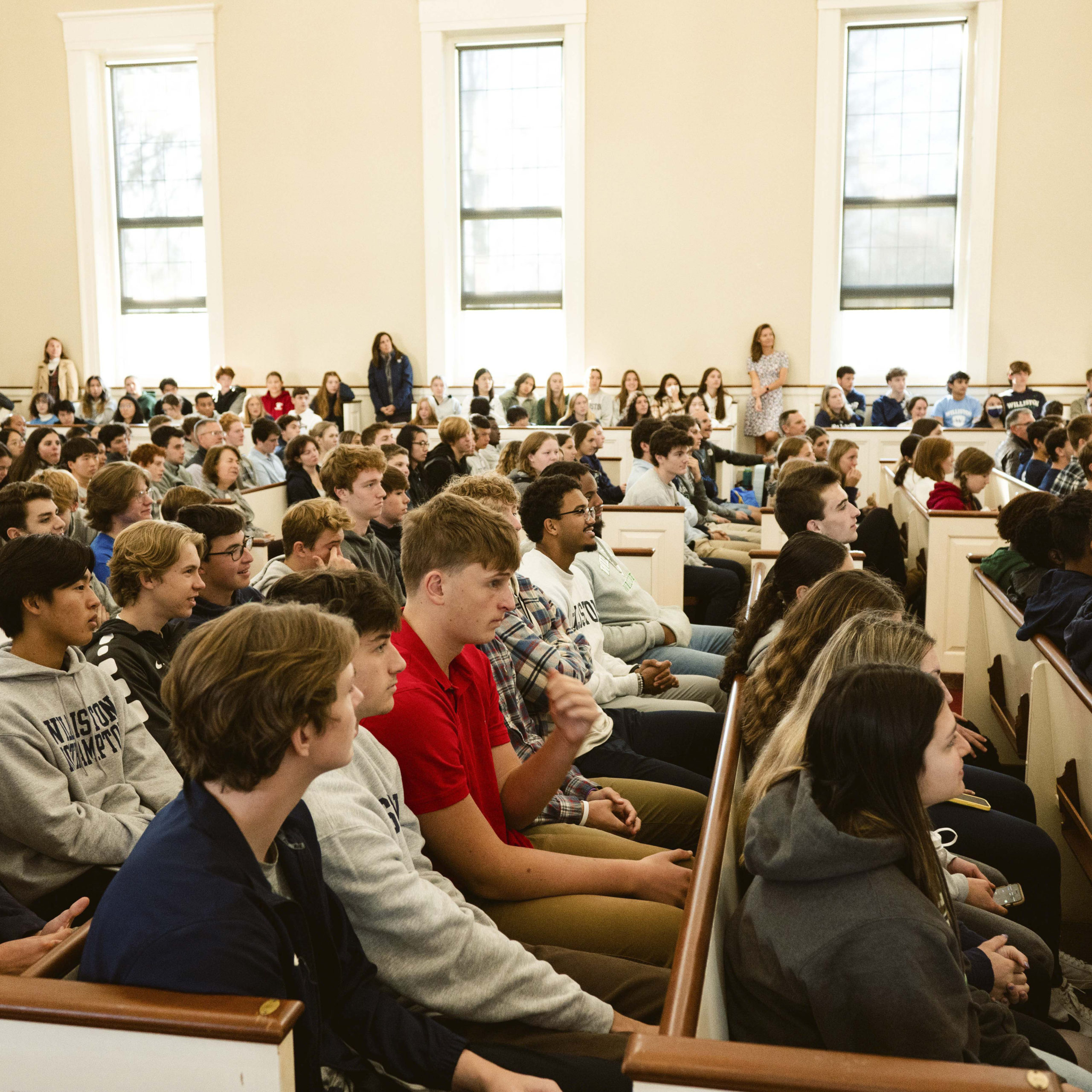 Students, faculty sit, stand in chapel for assembly