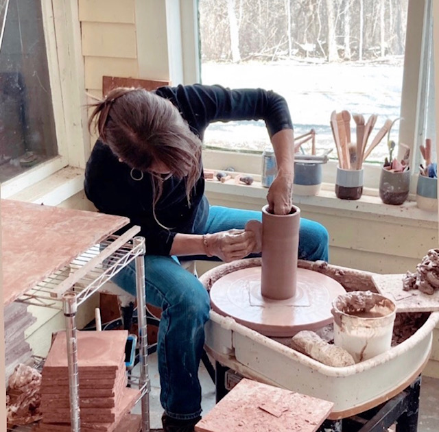 artist making pottery