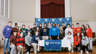 boys, girls williston students stand in chapel for athletic signing ceremony