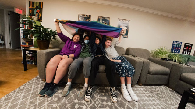 students on couch with flag