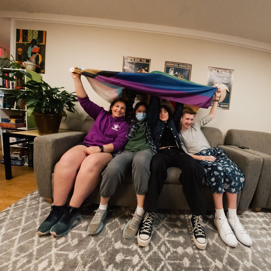 students on couch with flag