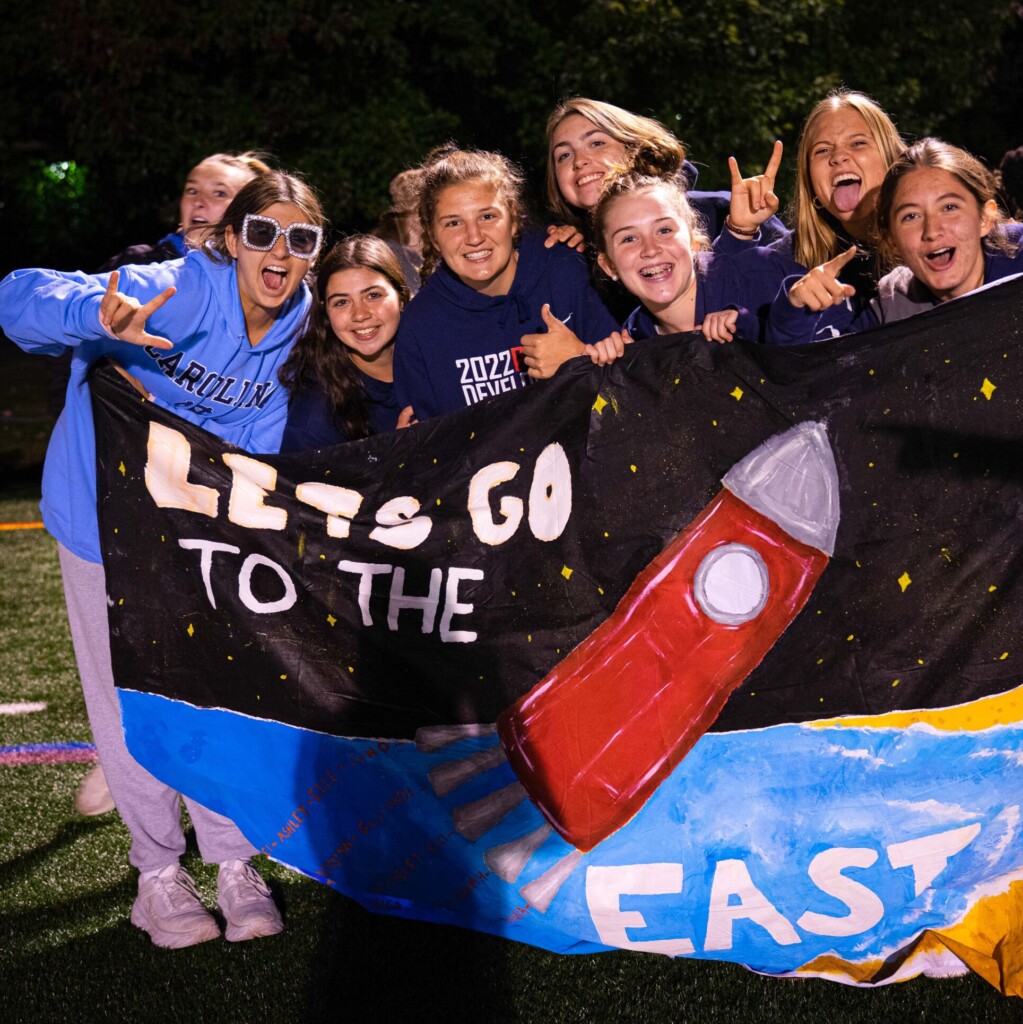 group of students holding banner