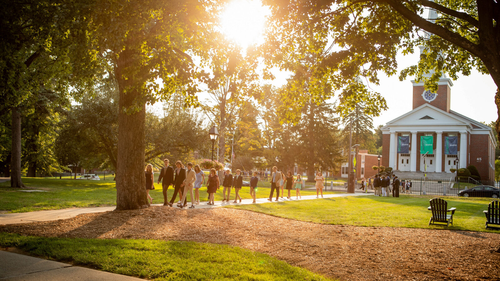 campus with chapel and students at sunset