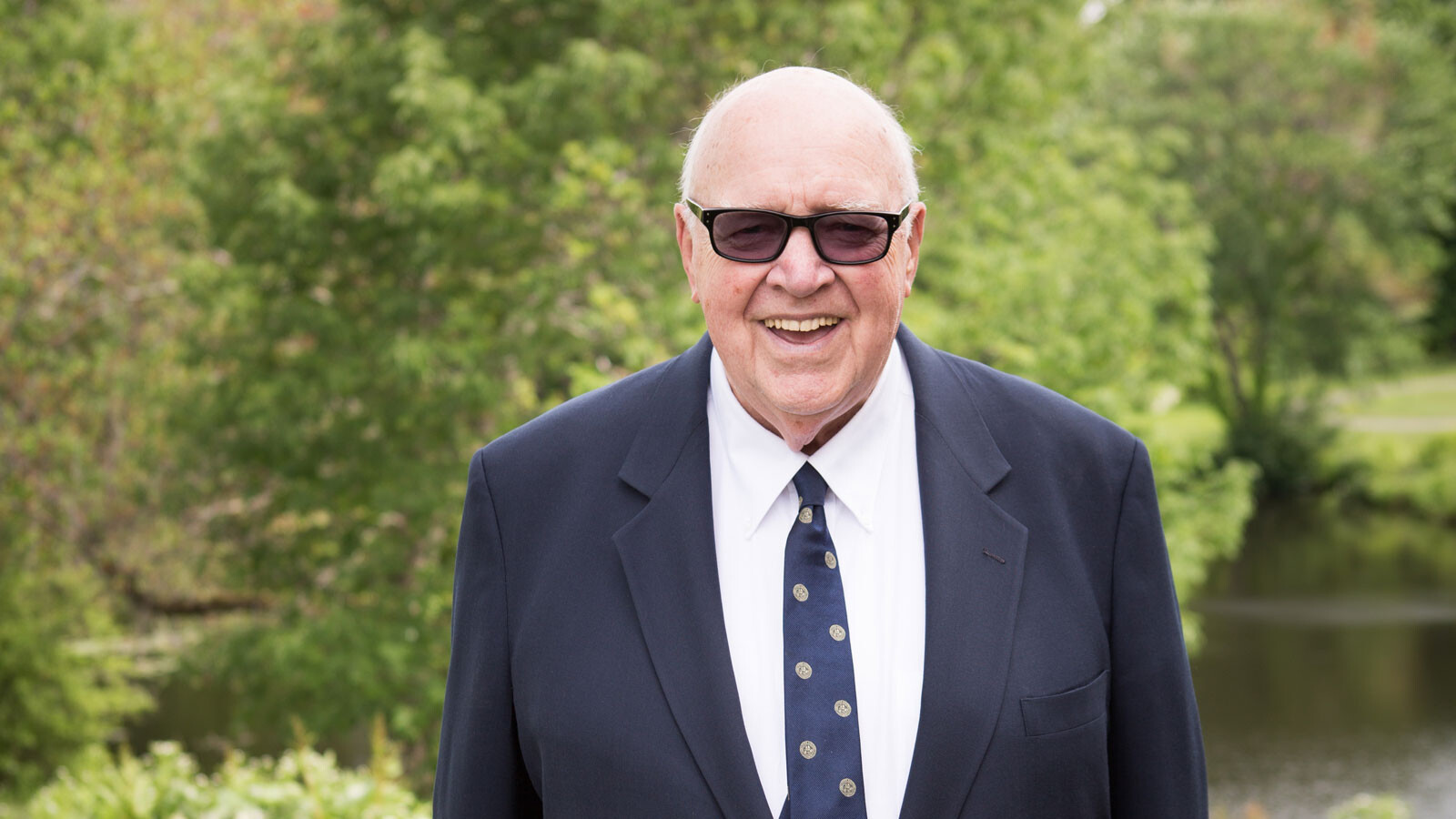 man in suit and sunglasses outdoors