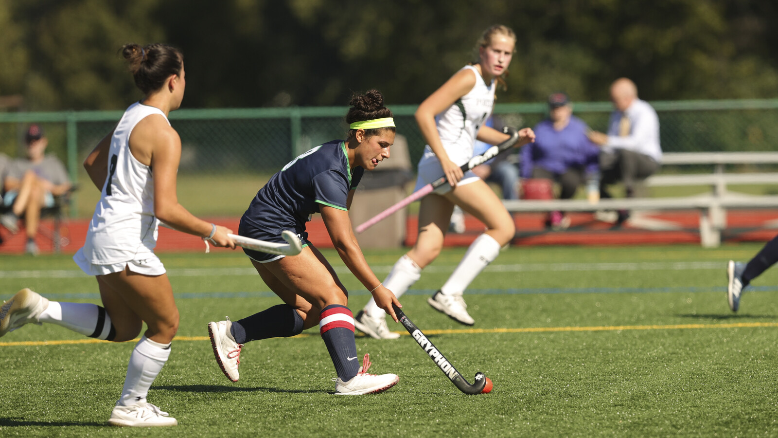 girls playing field hockey