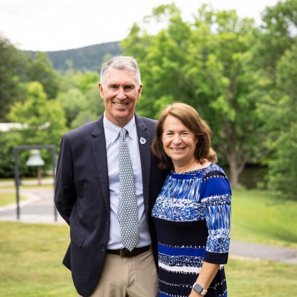 man and woman posing on lawn
