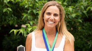 woman posing with trophy
