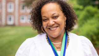 woman posing with medal