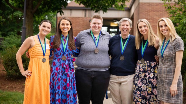 group of woman posing with medals