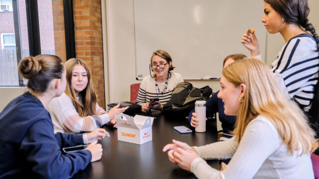 teacher at table with students