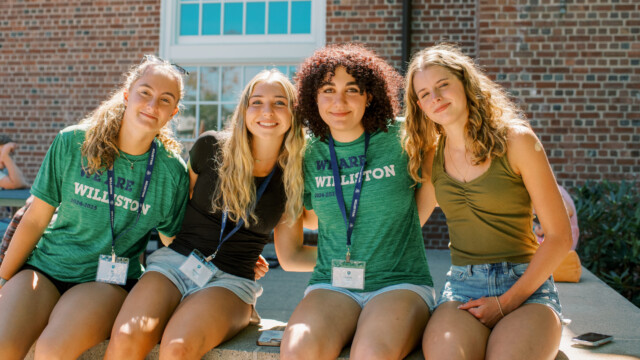 students sitting on a wall