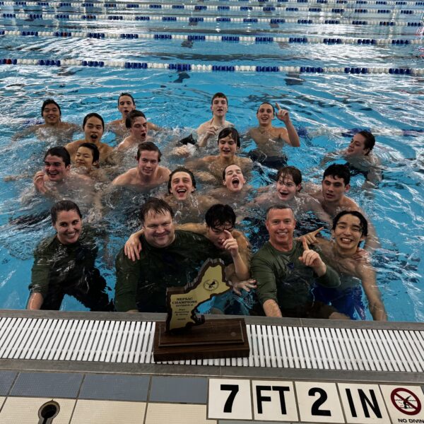 team in pool posing with trophy