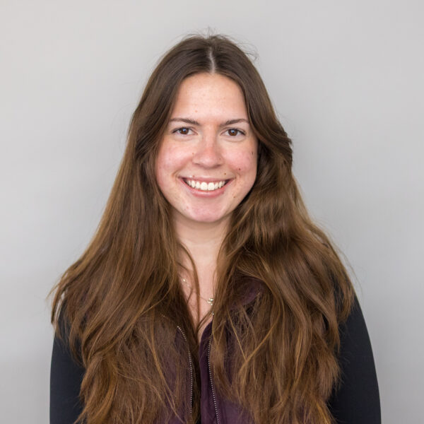 woman smiling on gray