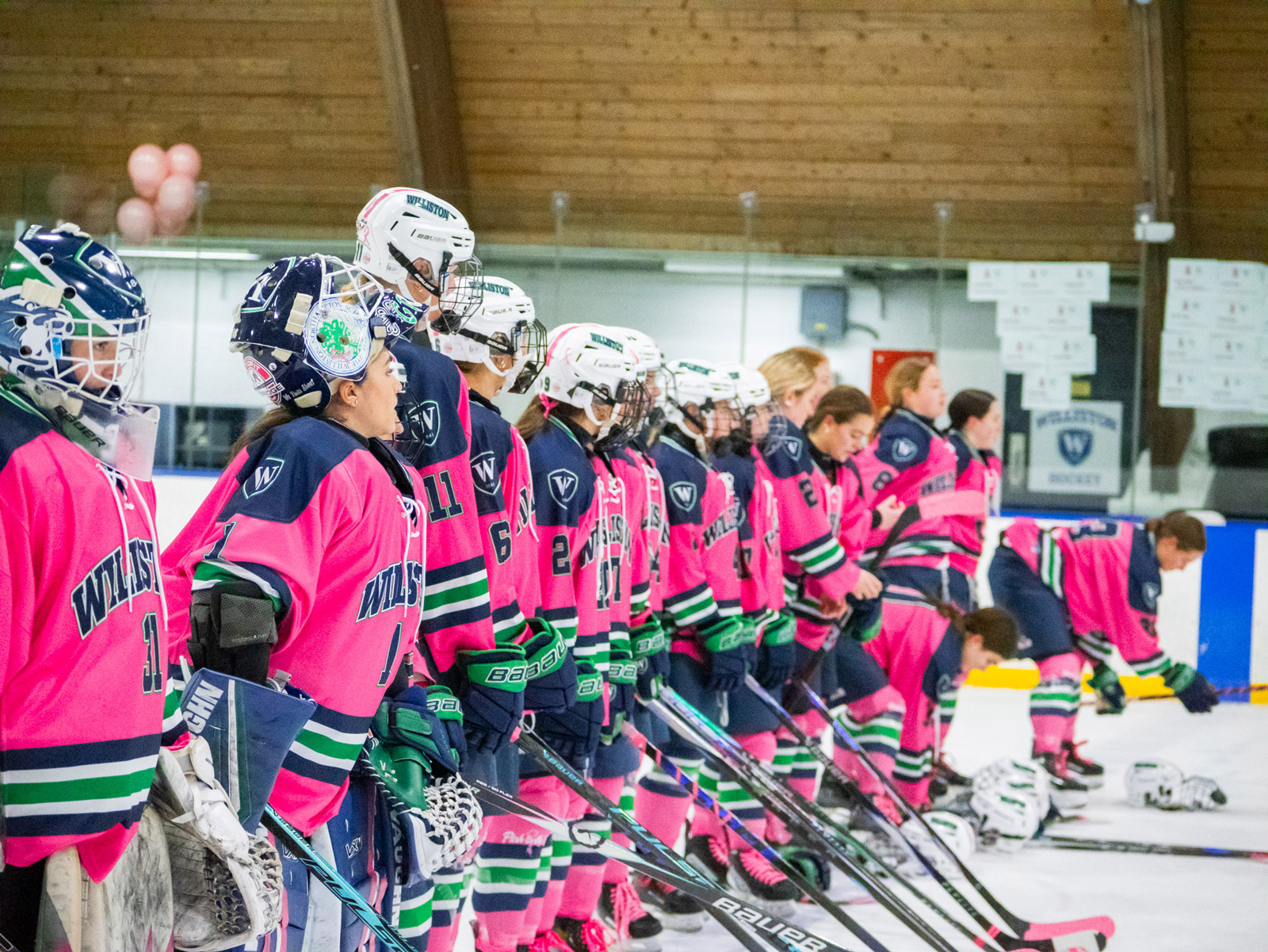Girls hockey players stand in line
