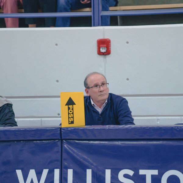 Williston teacher and coach sits at scorers table during basketball game