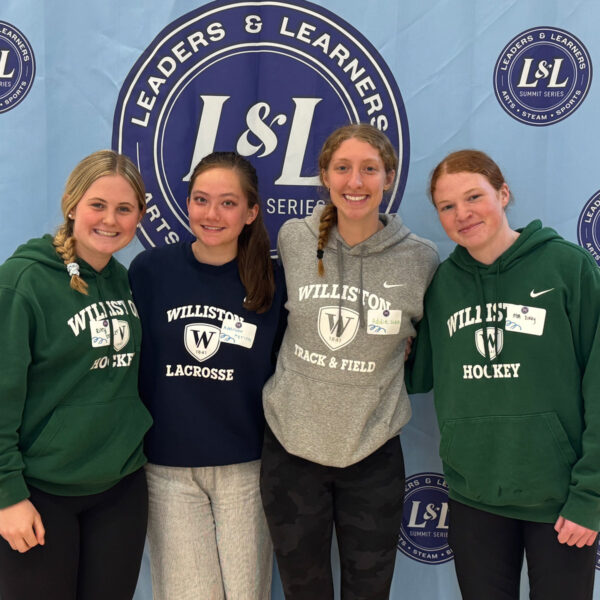 Four female Williston students pose for picture at 2026 Girls in Sports Leadership Summit