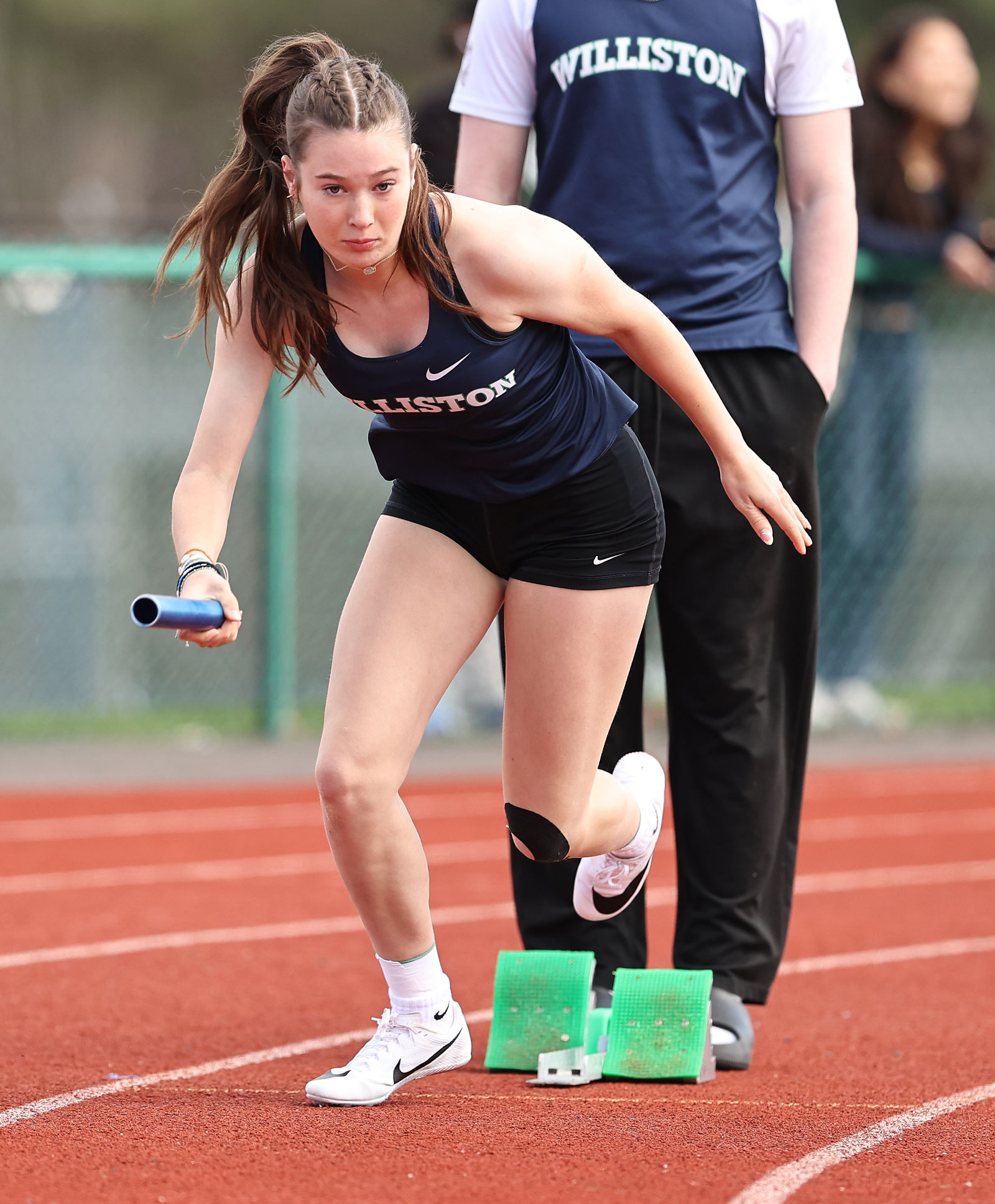 A Williston girls track runner starts a race off the blocks