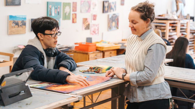 teacher and student in art classroom