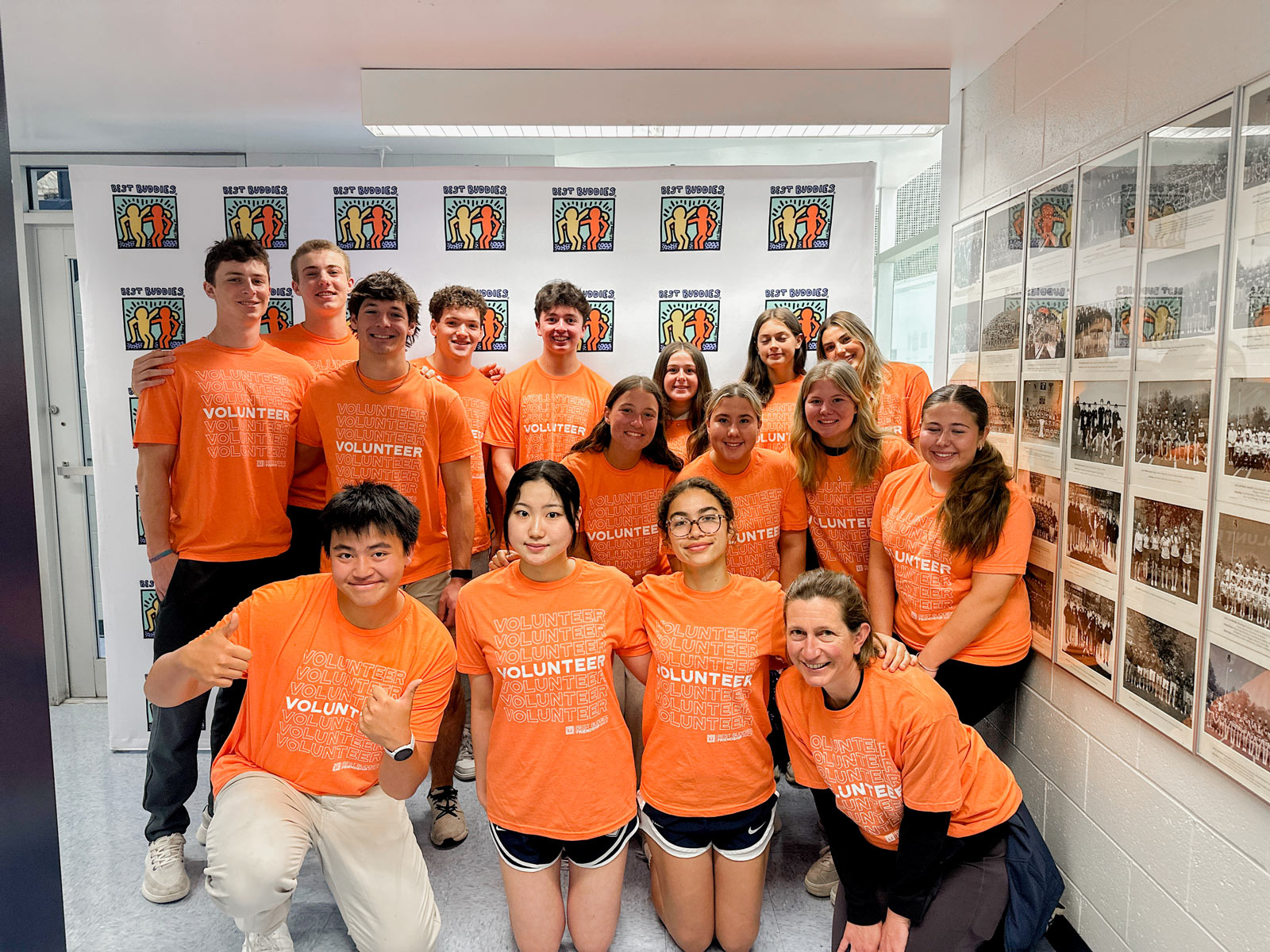 A group of Williston students pose for a picture in the gym during a Best Buddies Friendship Walk event