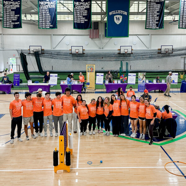 A group of Williston students pose for a picture in the gym during a Best Buddies Friendship Walk event