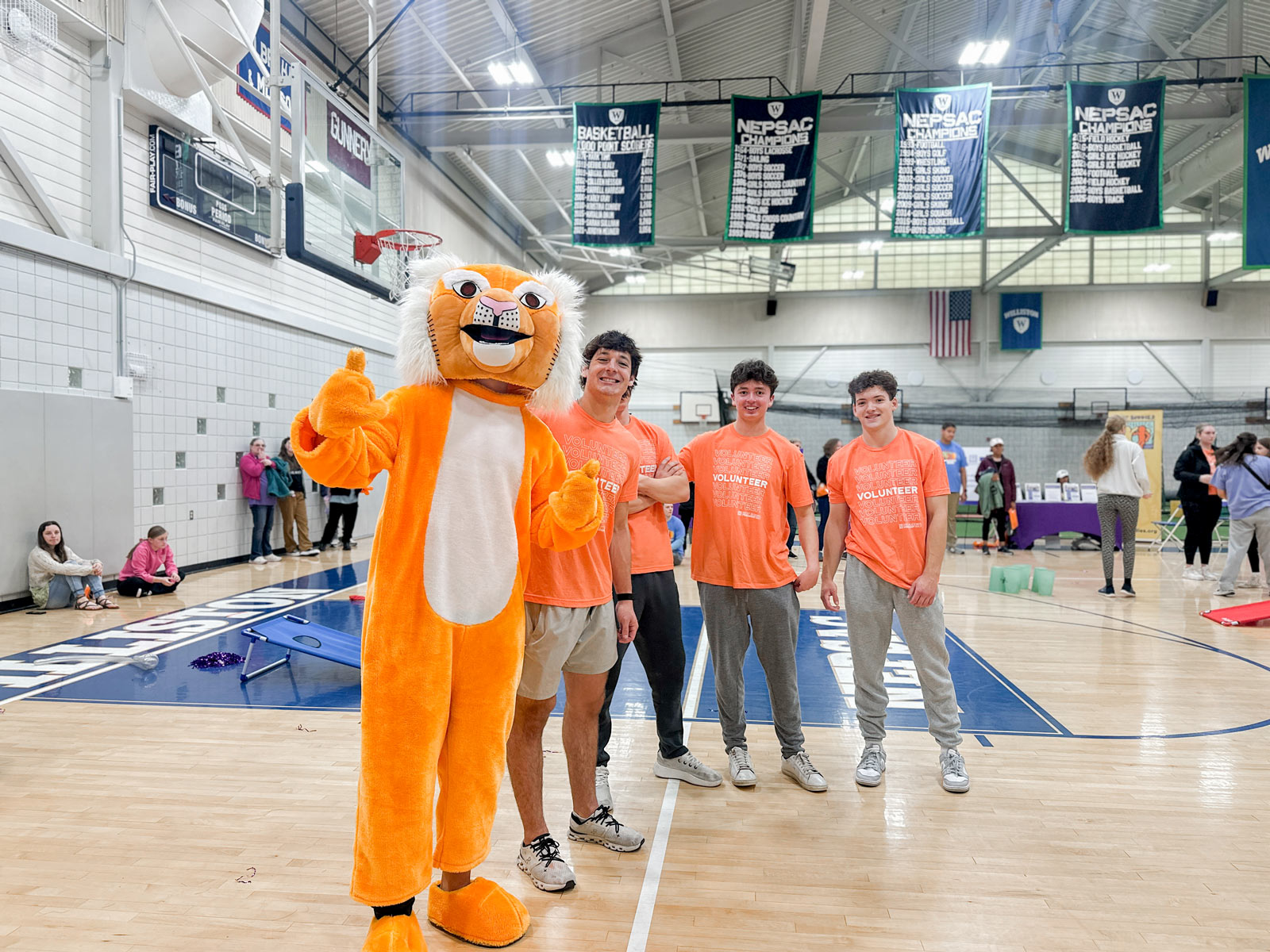 A group of Williston students pose for a picture in the gym during a Best Buddies Friendship Walk event