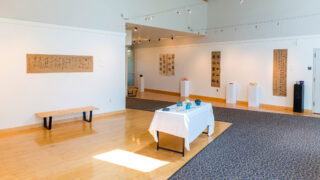 art gallery with art on walls and tables