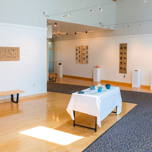 art gallery with art on walls and tables