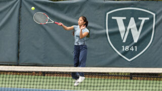 A Williston female tennis player hits a ball during a match