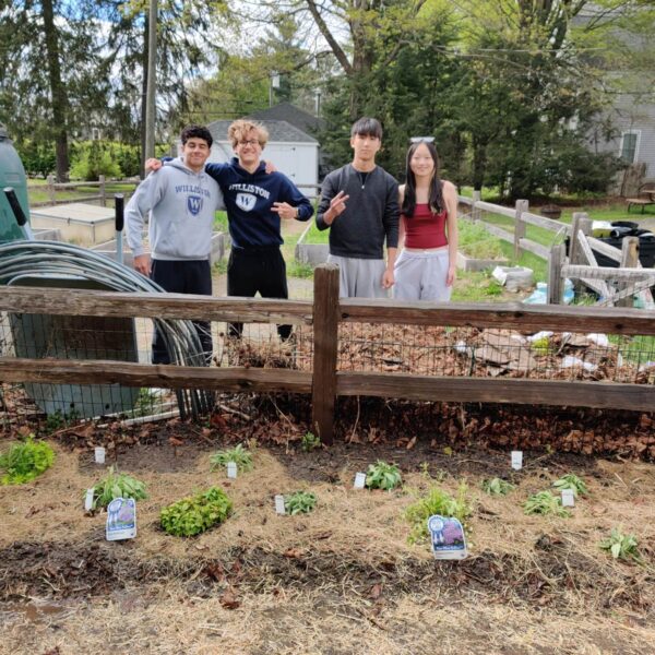 Four Williston students pose for picture in the Community Garden