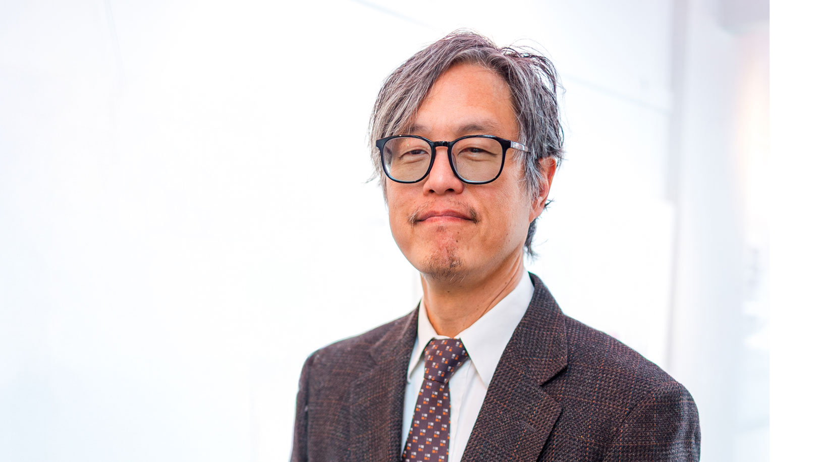 Male teacher in glasses, jacket, and tie