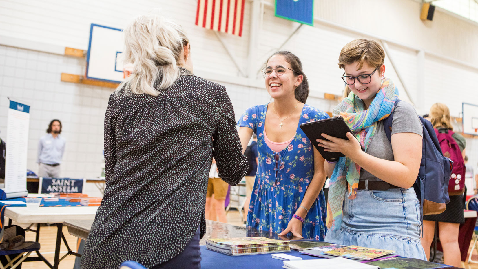 students talking to college representative